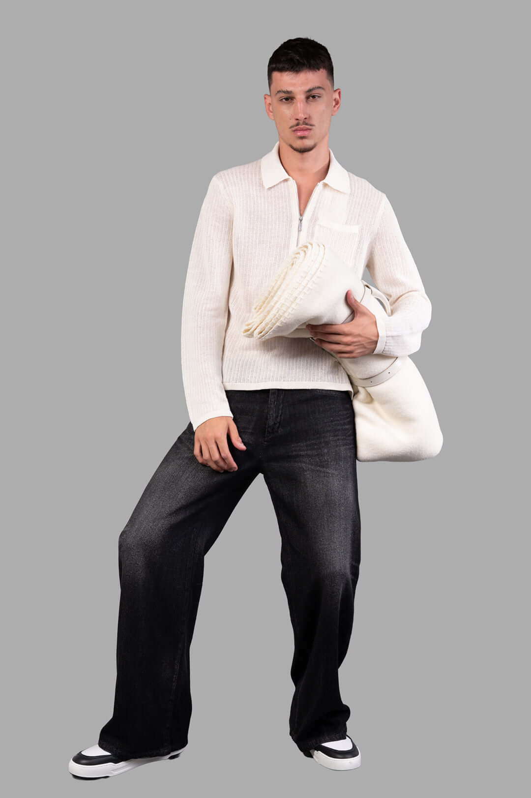 Helmut Lang long-sleeve zip polo in white linen, shown on model holding a rolled linen item, textured knit fabric.