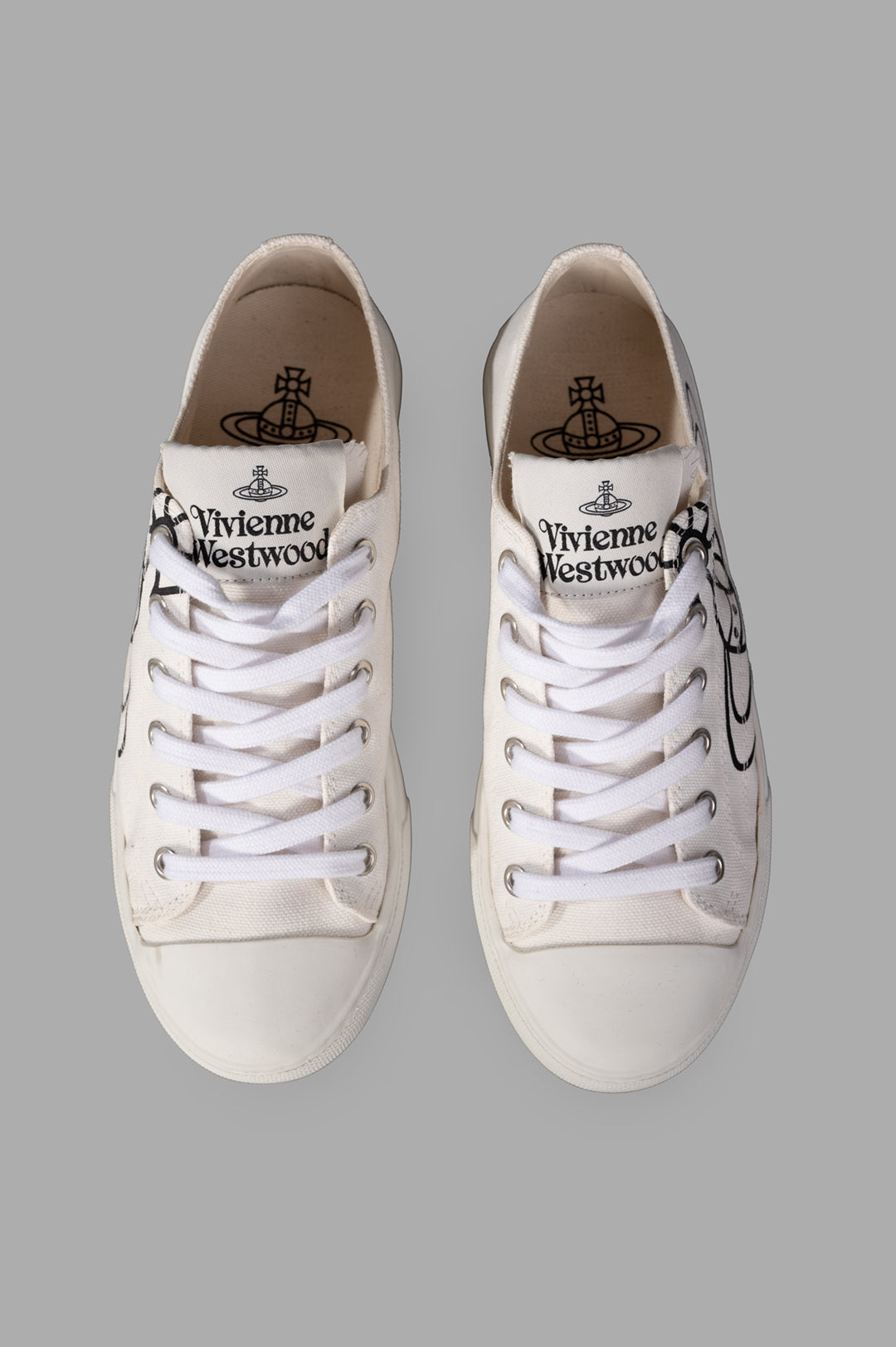 Vivienne Westwood Plimsoll Low Top Canvas Sneakers in white, featuring laces, logo detailing, and a breathable canvas upper.