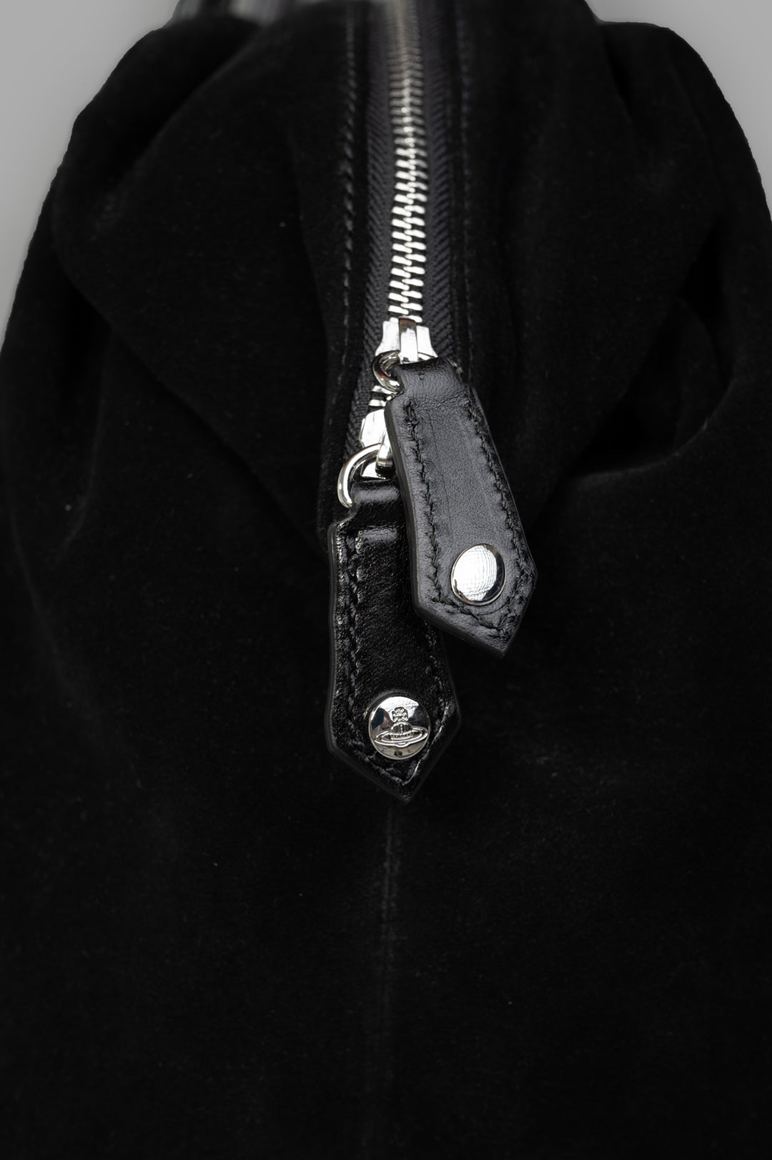 Vivienne Westwood Shirley Holdall close-up of the zipper and branded pull tabs, highlighting craftsmanship in smooth leather.