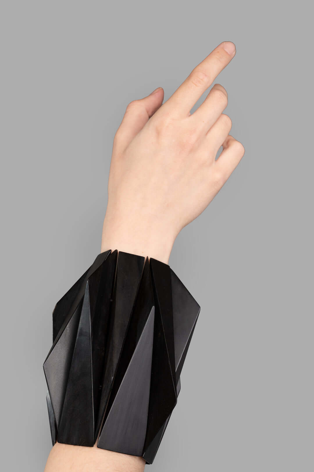Monies Oversized Angular Bracelet in ebony features a striking geometric design worn on the wrist for a bold statement.
