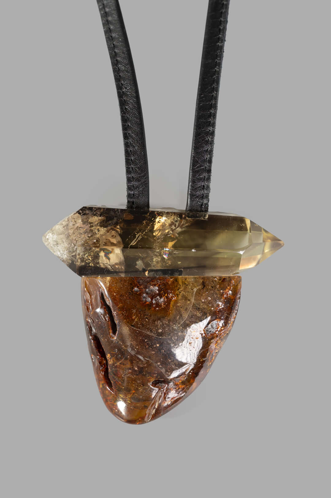 Monies Pendant Necklace with a striking amber and citrine pendant suspended from a sturdy leather cord, highlighting.