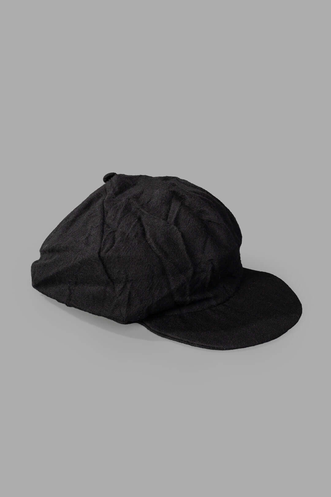 Marc Point black newsboy cap side view, featuring premium wool fabric and a reinforced brim for durability.