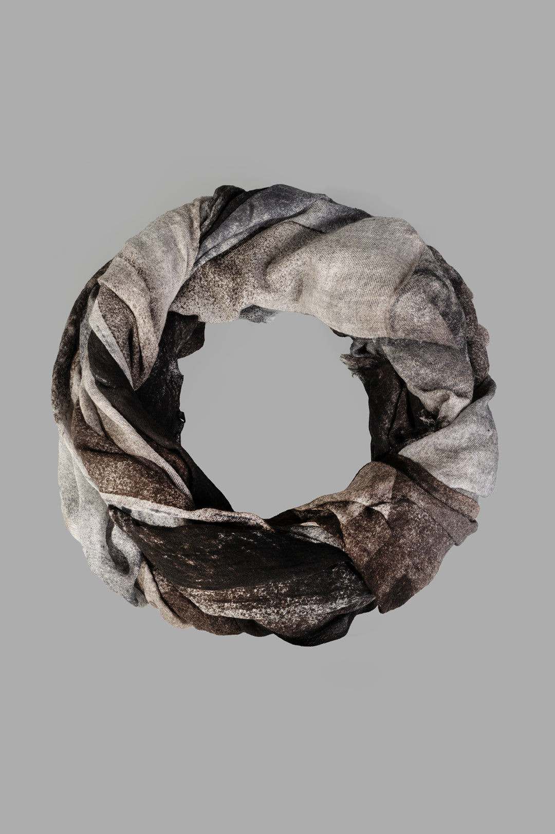 Avant Toi Graphic-print Scarf in Black, close-up of folded wool scarf showing grey and black print with frayed edges.