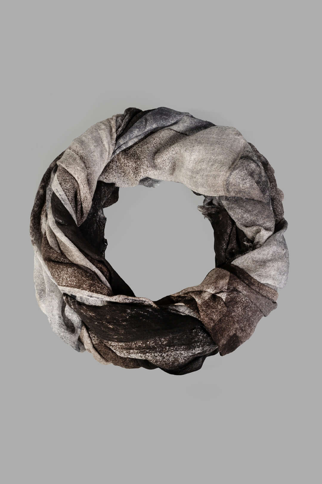 Avant Toi Graphic-print Scarf in Black, close-up of folded wool scarf showing grey and black print with frayed edges.