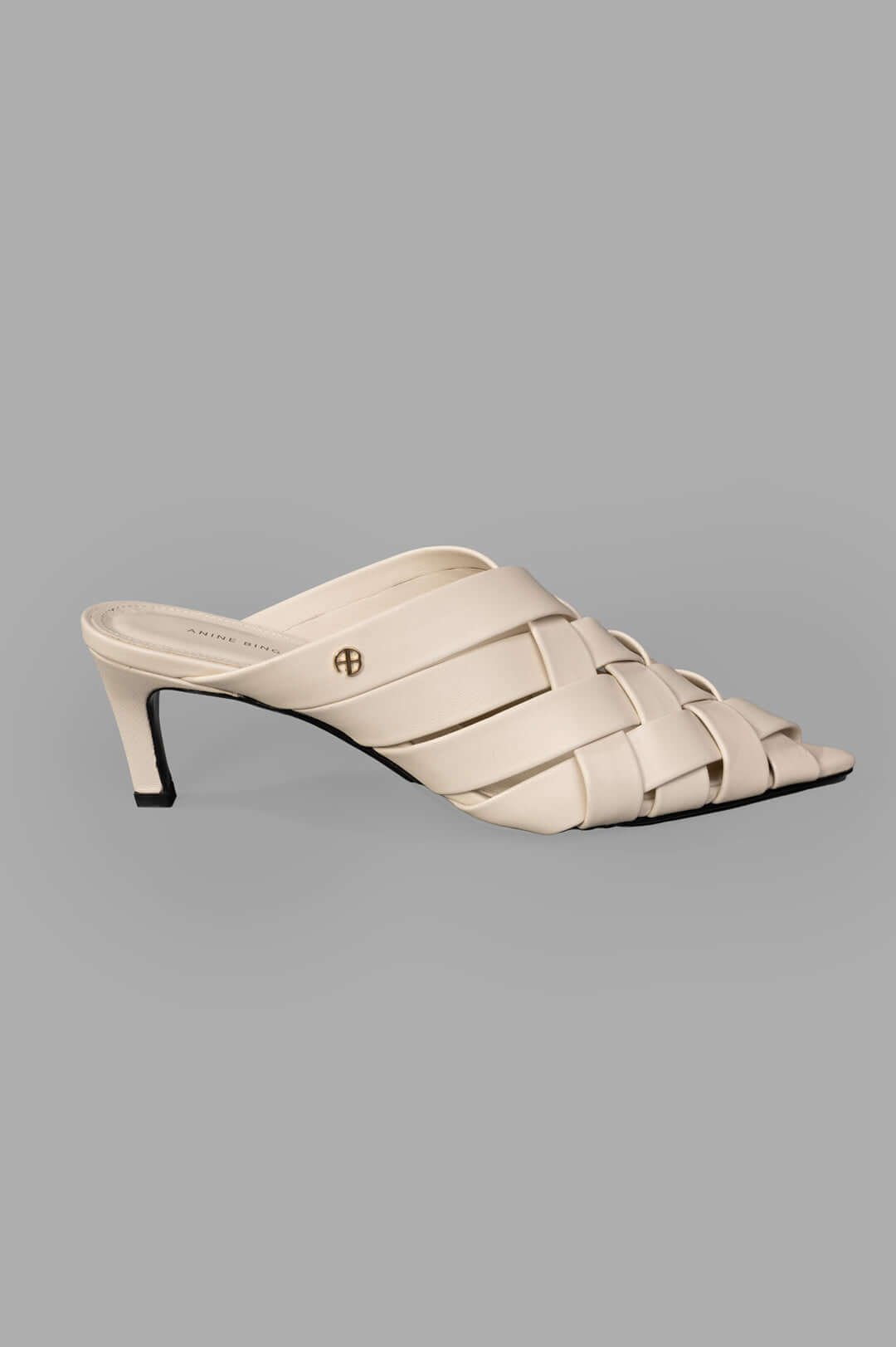 Anine Bing Eve Mules side view in bone, woven leather straps with a small heel.