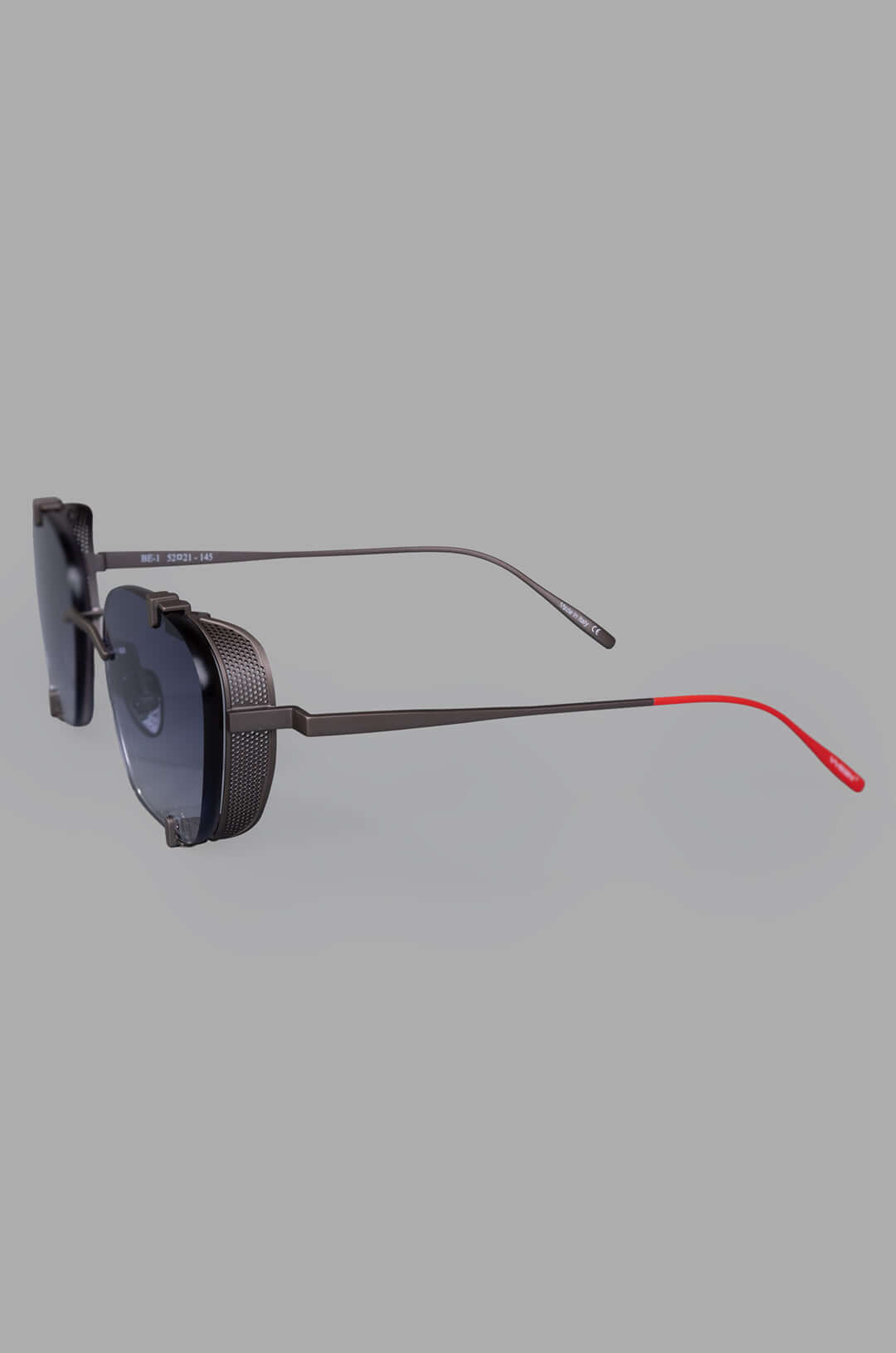 Vysen Eyewear. The Bei - BE2 rimless titanium sunglasses showcasing a sleek side view with stylish red accents.