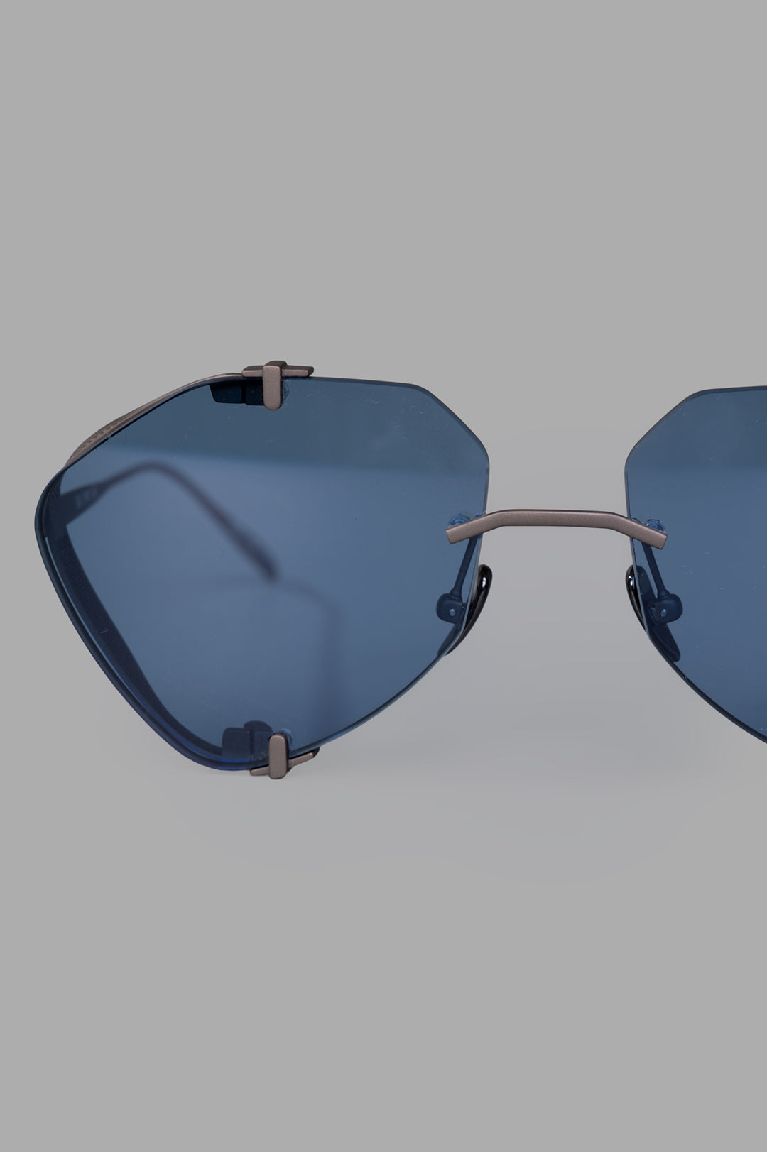 Vysen Eyewear The Khoid - KH5 features bold rimless titanium aviator sunglasses with clear blue lenses and unique frame.