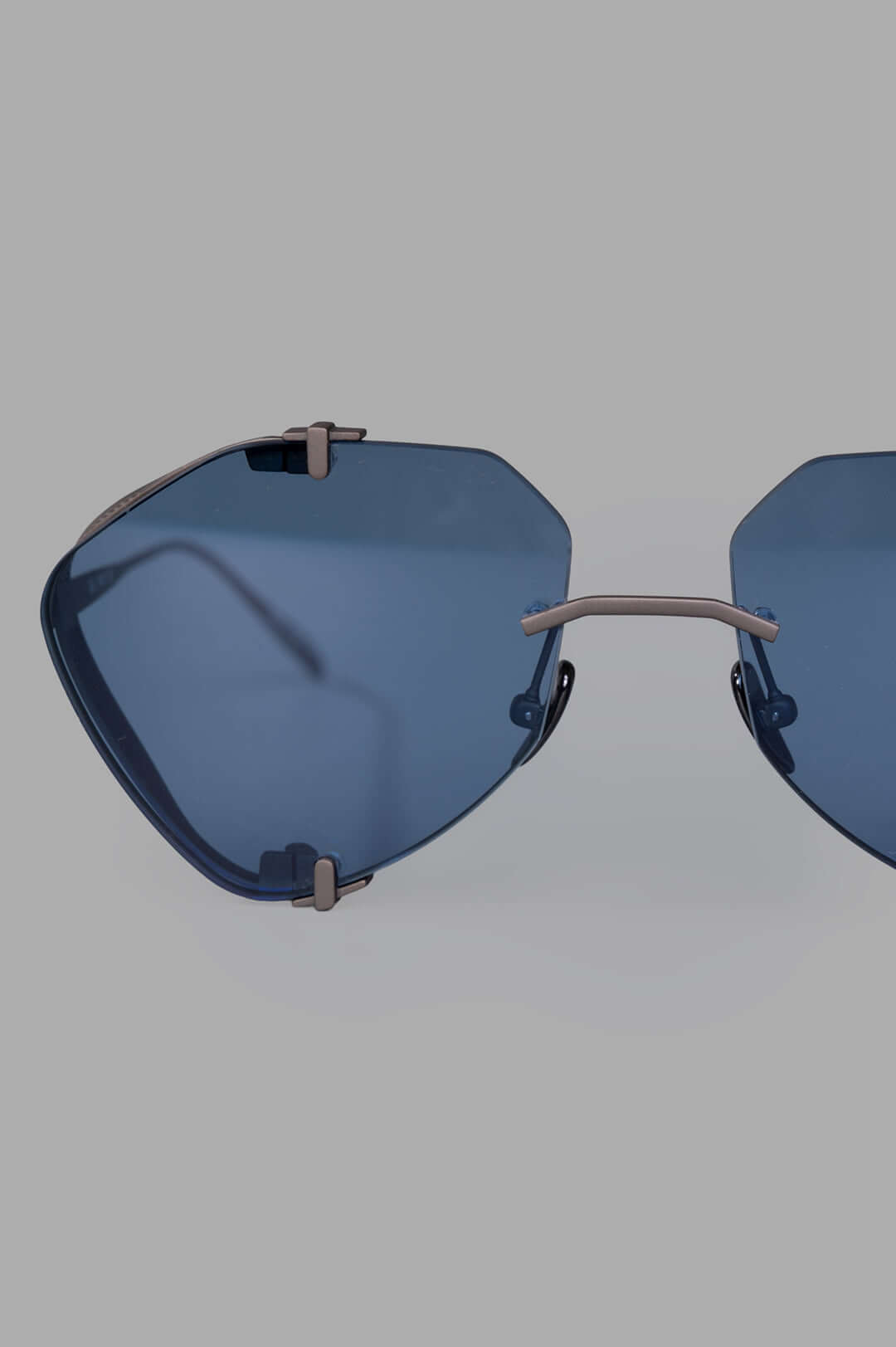 Vysen Eyewear The Khoid - KH5 features bold rimless titanium aviator sunglasses with clear blue lenses and unique frame.