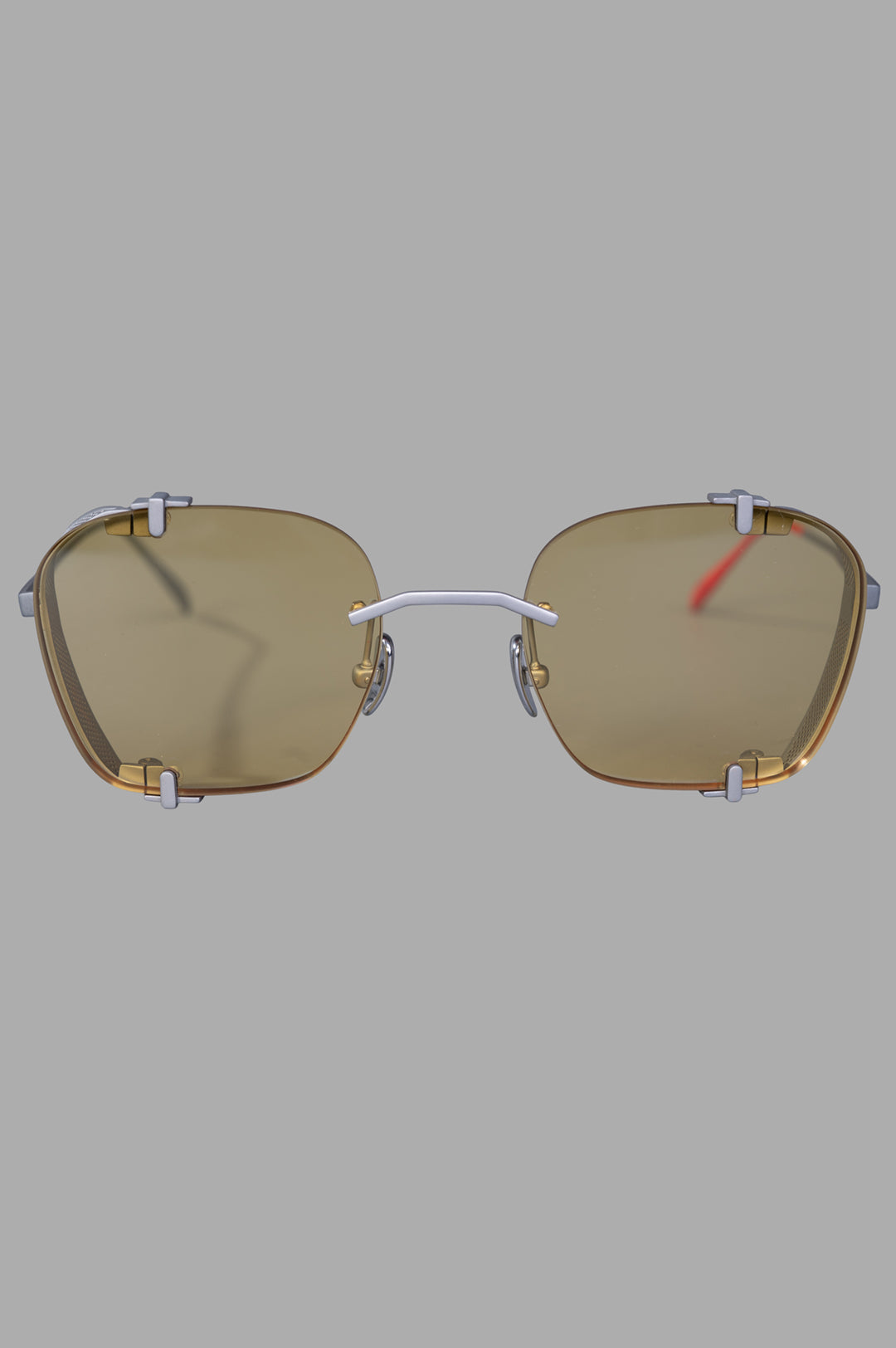 Vysen Eyewear The Bei - BE3 rimless sunglasses front view, showcasing sleek silver matte titanium and clear yellow lenses.