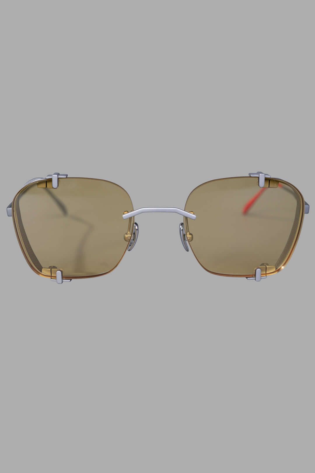Vysen Eyewear The Bei - BE3 rimless sunglasses front view, showcasing sleek silver matte titanium and clear yellow lenses.