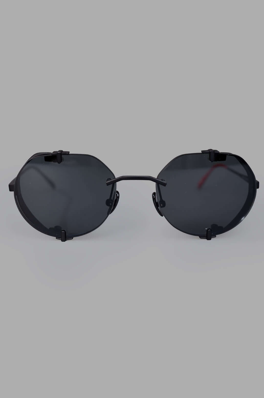 Vysen Eyewear The Uttar - UT1 black matte rimless titanium round sunglasses, front view, highlighting minimalist design.