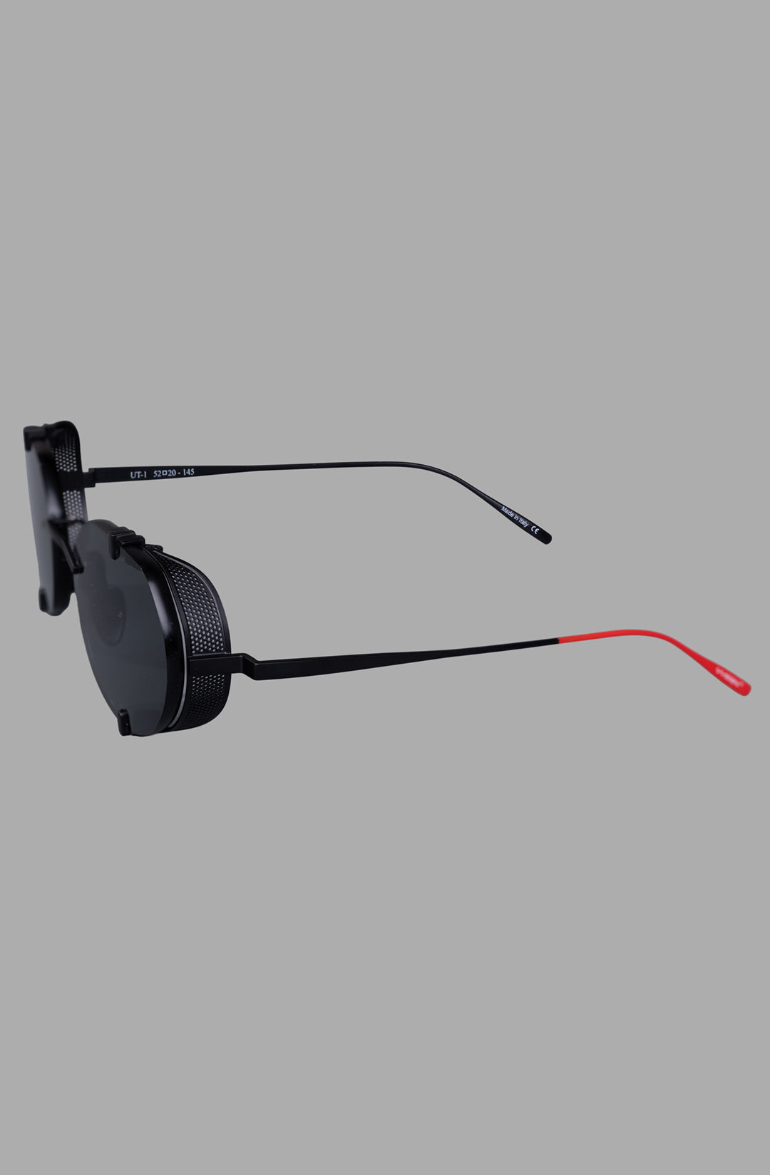 Vysen Eyewear The Uttar - UT1 showcases a side view of the rimless black matte titanium frame with striking red temples.