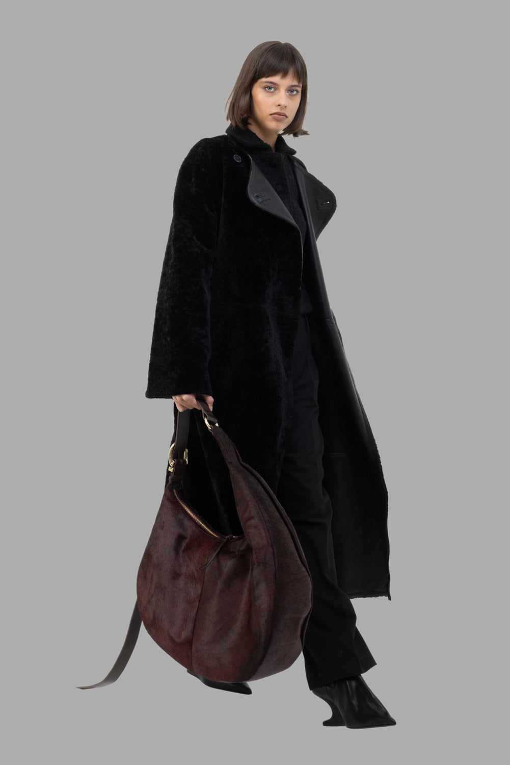 By Malene Birger women's reversible shearling coat in black, on-model full length, leather lapel reveals reversible design