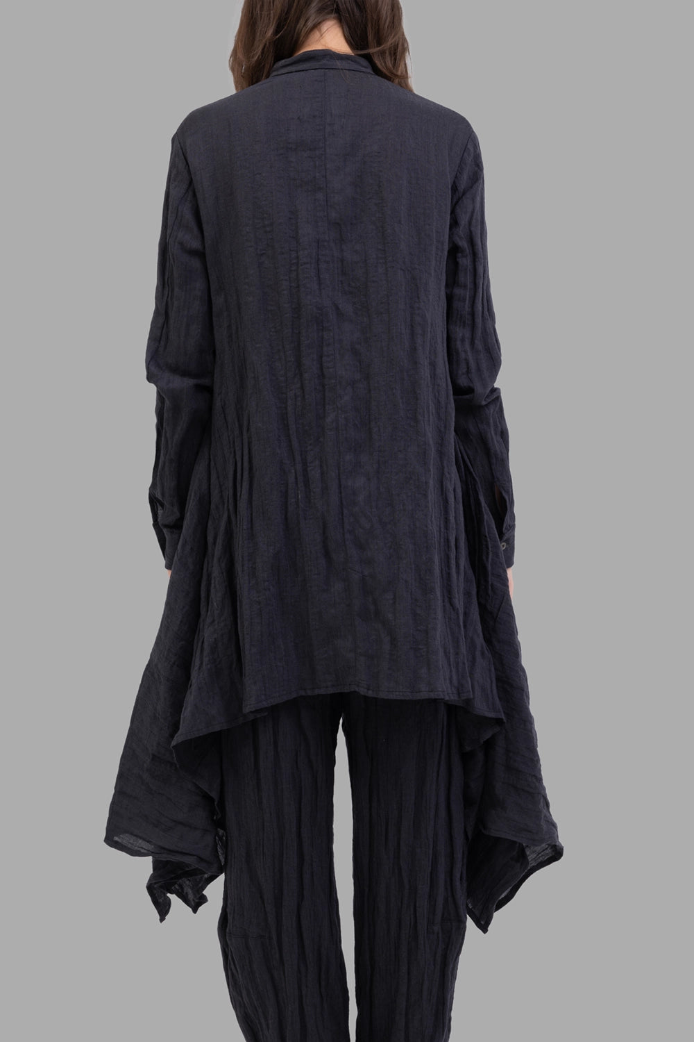 Marc Point women's black shirt, back view, long draped sides and center seam.