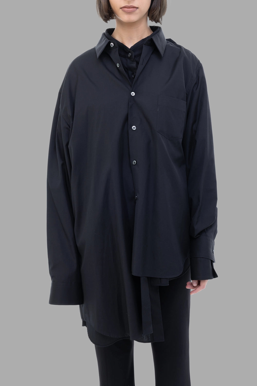 Comme des Garçons women black shirt, front view, layered placket with chest pocket and long cuffs.