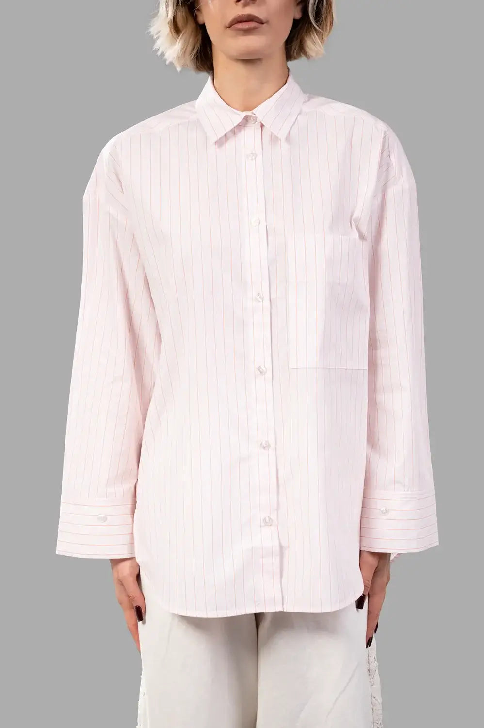 Front close-up of pink pinstripe shirt showing point collar, button placket, chest pocket