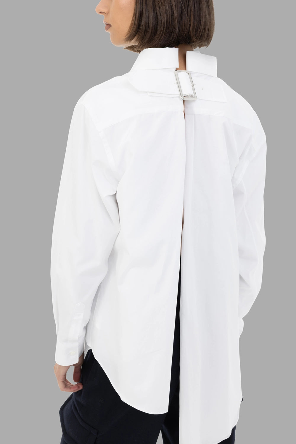 Comme des Garçons women's shirt in white, back view, deep center slit with adjustable buckle at neck