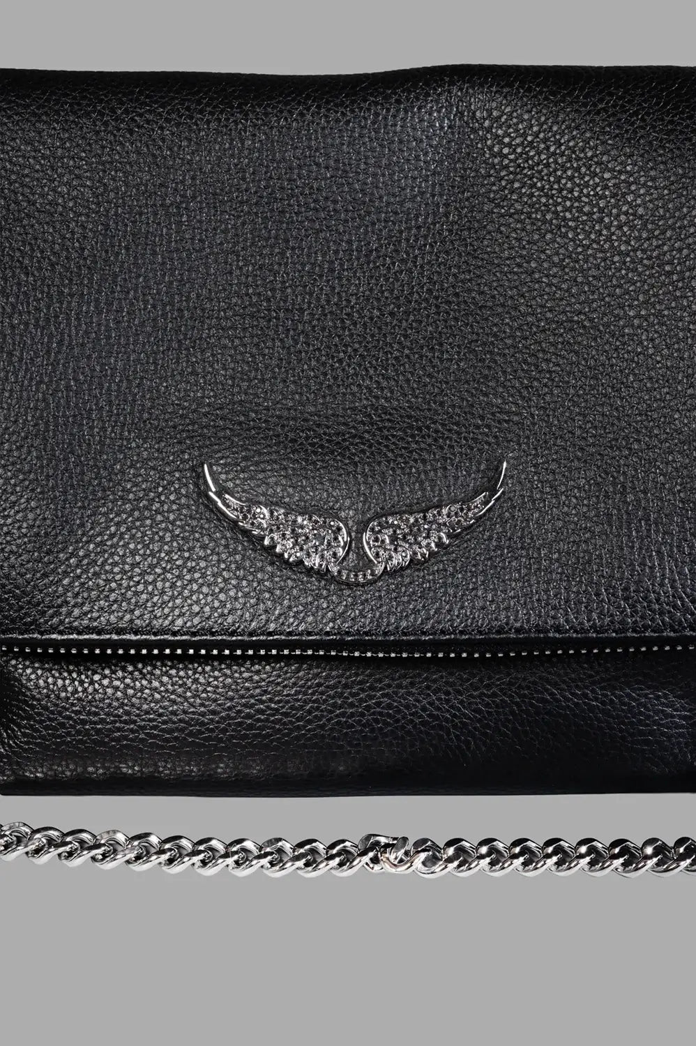 Zadig & Voltaire shoulder bag in black, logo close-up, crystal-studded wings on pebbled leather above zipper