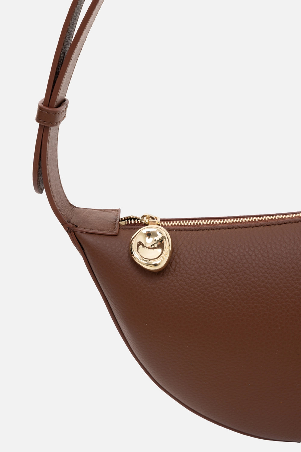 JOSEPH leather shoulder bag in cinnamon, hardware close-up, gold bean zip pull with pebbled grain finish