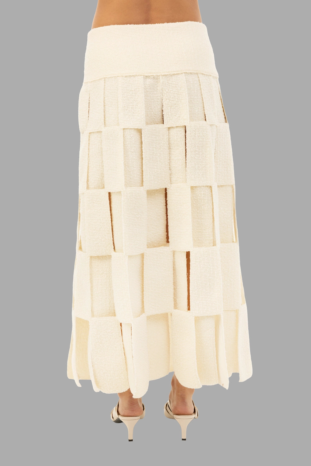 A.W.A.K.E. MODE women maxi skirt in ecru, back view, layered rectangle panels and ankle-grazing length.