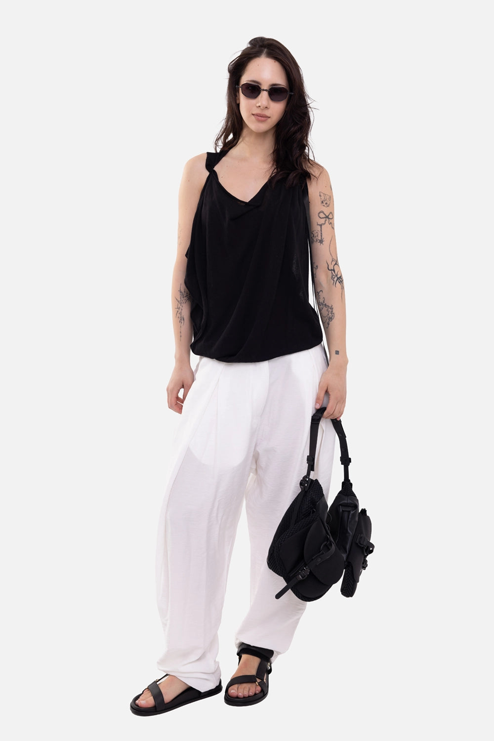 Gianluca Capannolo women's vest in black, on-model full length, draped wrap front over white trousers