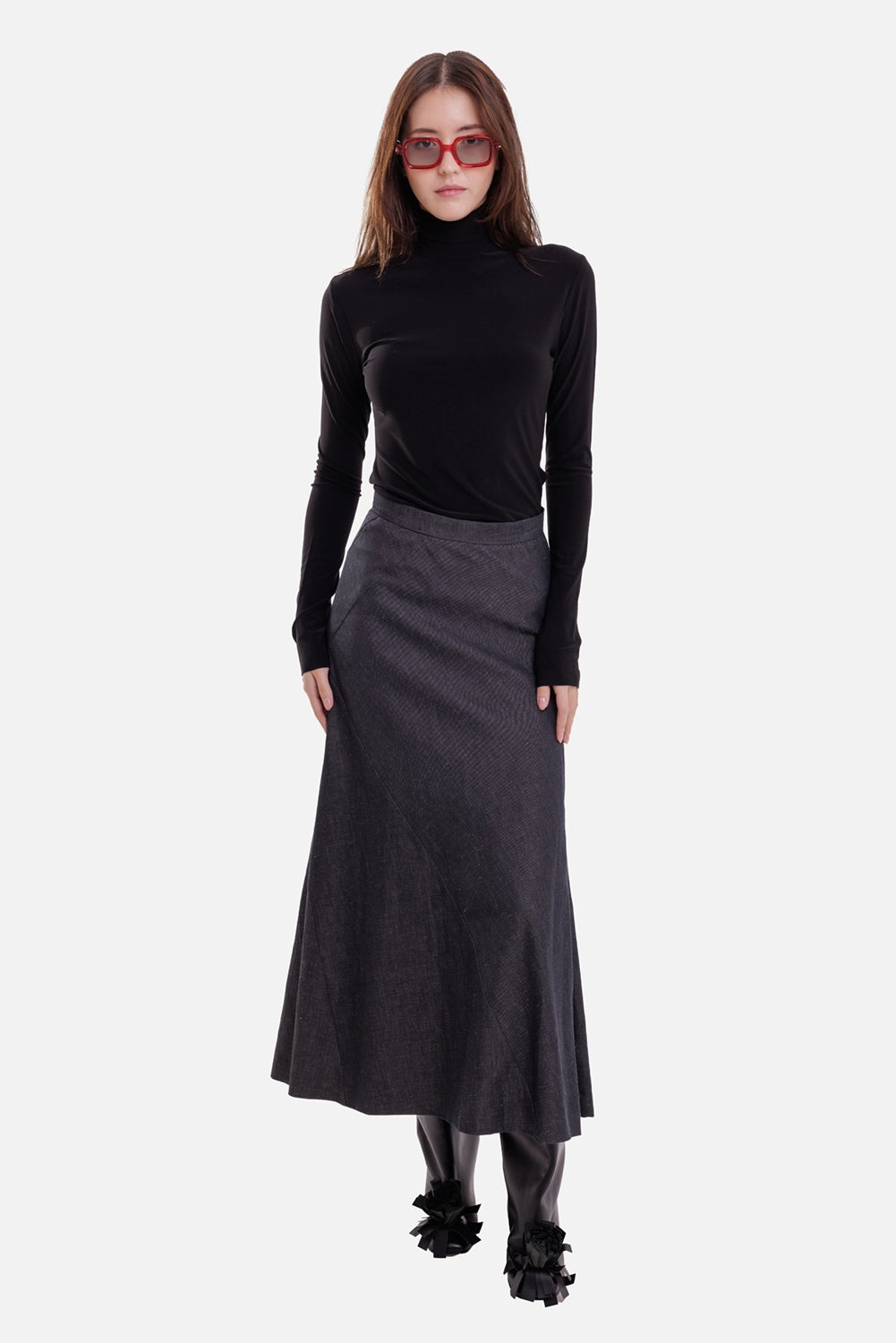 Norma Kamali women's black turtleneck top, on-model full-length view with slim fit and thumbhole cuffs