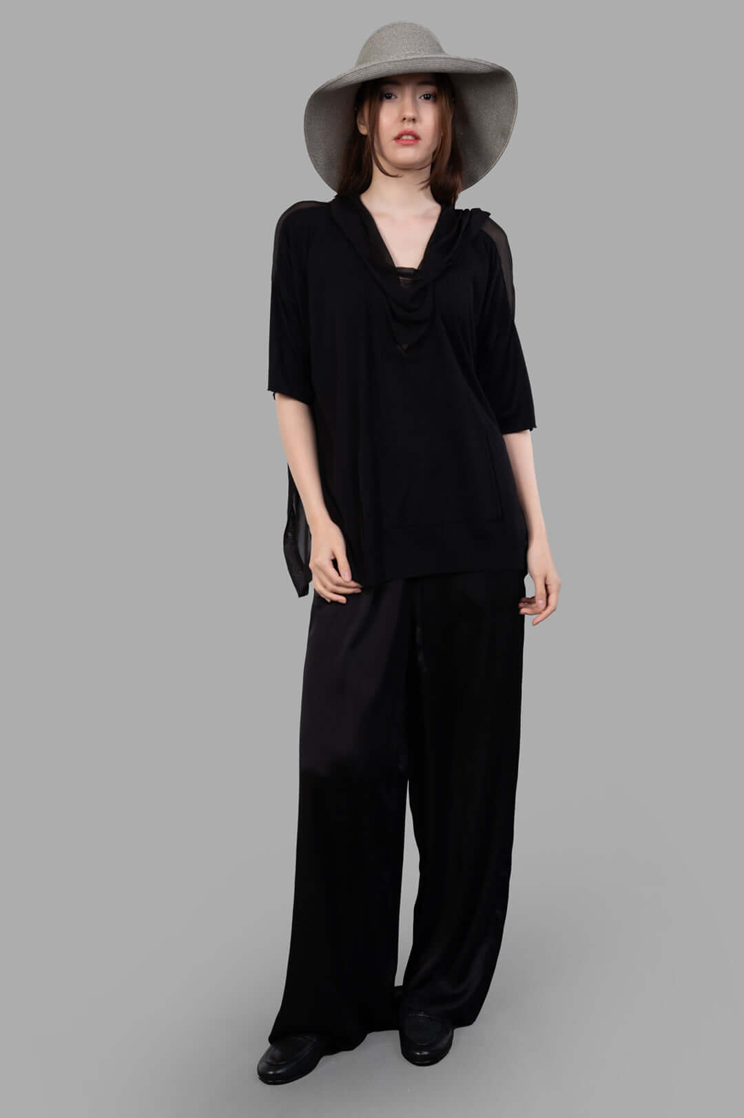 Masnada Layered T-shirt in black silk, front view with shawl collar and hood, worn by model, showcasing abbreviated sleeves.