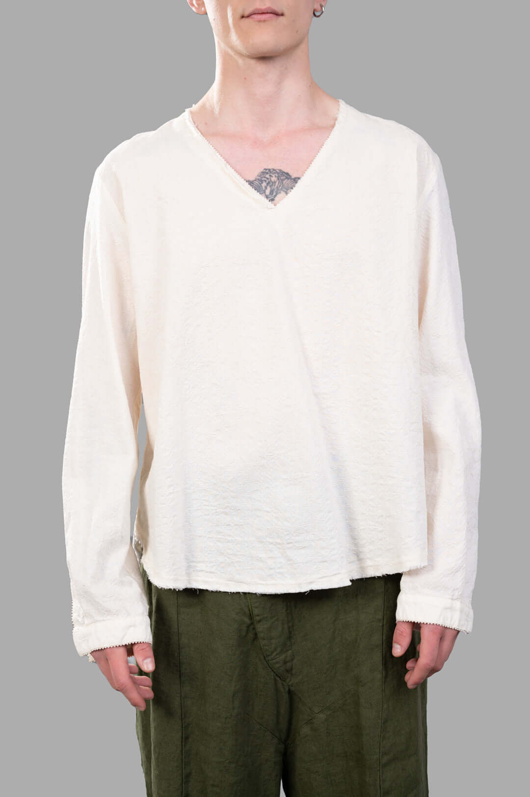 Marc Point V-neck Blouse in ecru, showcasing a relaxed fit and asymmetric hem, worn on a model for style context.