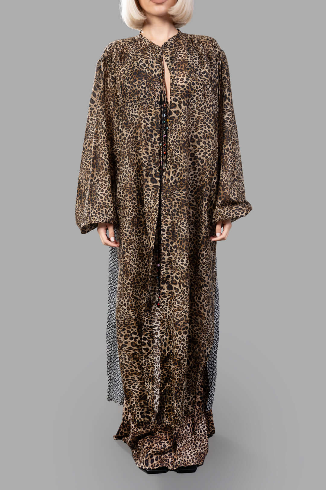 Anjuna Leopard Cape on model, featuring elegant leopard print, beaded tie closure, and delicate back graphic detail.