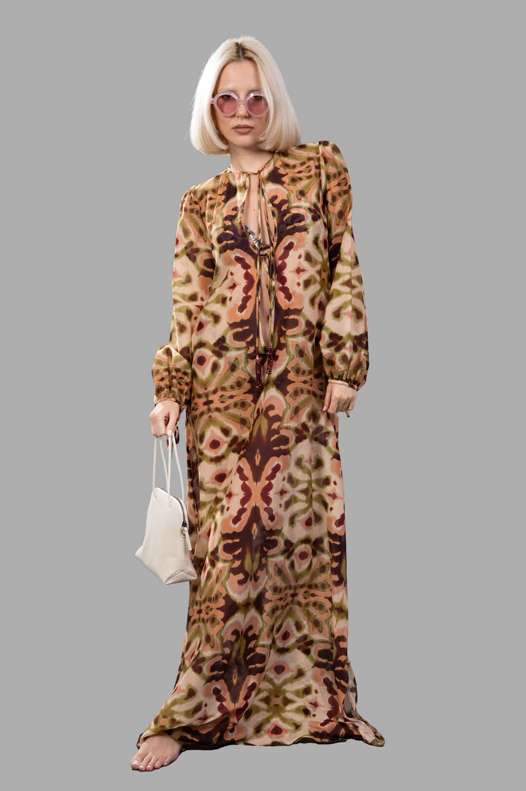 Anjuna Abstract-print Maxi Dress on model, front view, with pink sunglasses and a white purse.
