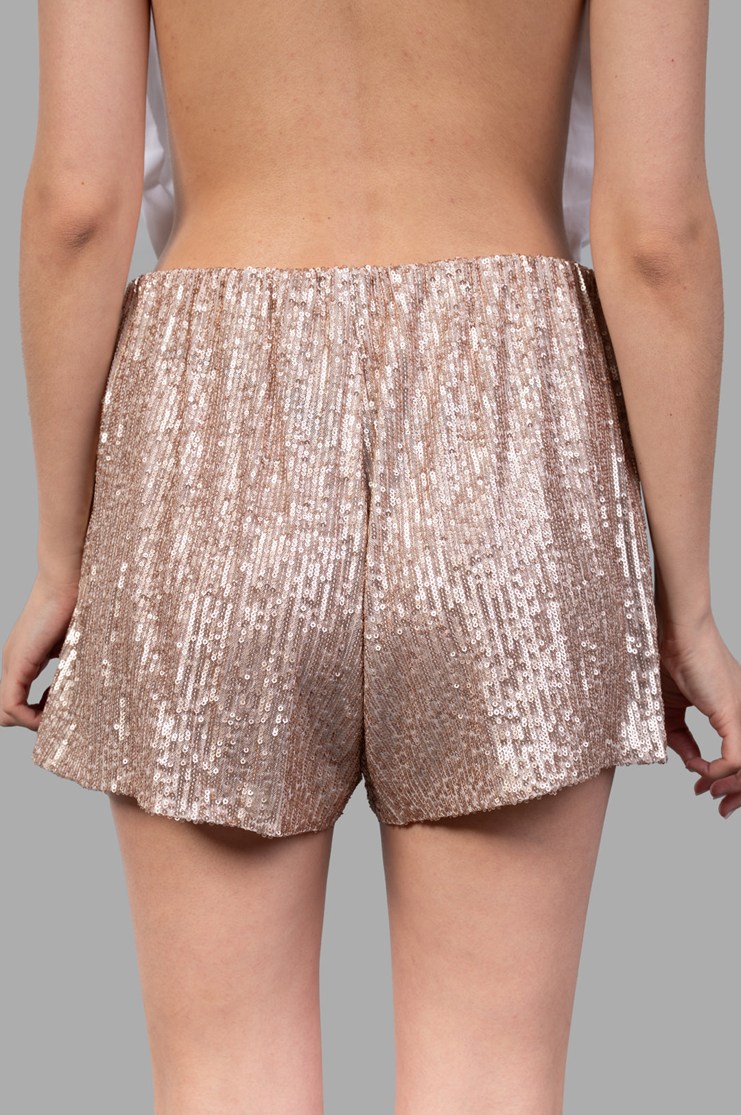 Norma Kamali Sequined Shorts showcase a dazzling back view, featuring a soft elastic waistband and all-over sequins.