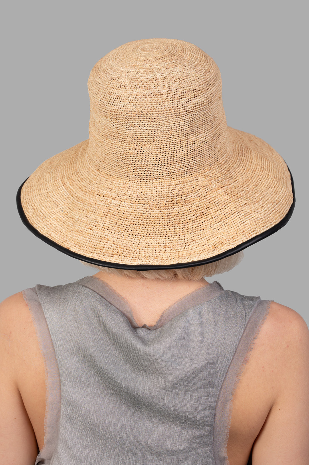 Kijima Takayuki Straw Mushroom Hat, showcasing a close-up of the beige raffia texture and black trim from the back view.