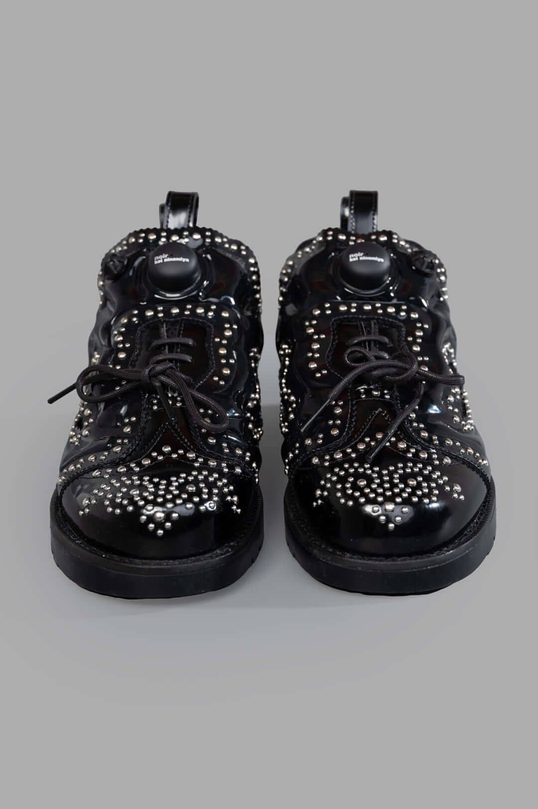 Noir Kei Ninomiya x Reebok Instapump Fury Sneakers showcase studded detailing and lace-up design, seen from the front.