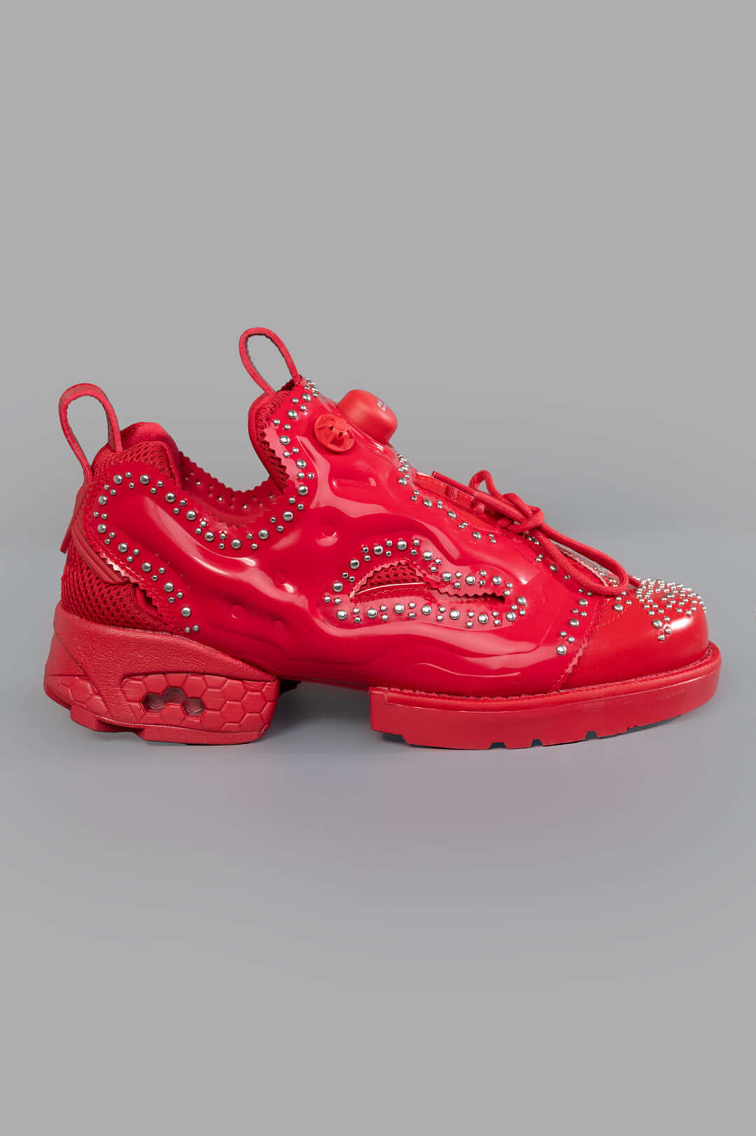 Noir Kei Ninomiya x Reebok Instapump Fury Sneakers in Red, side view with stud details and lace-up design, polyurethane.