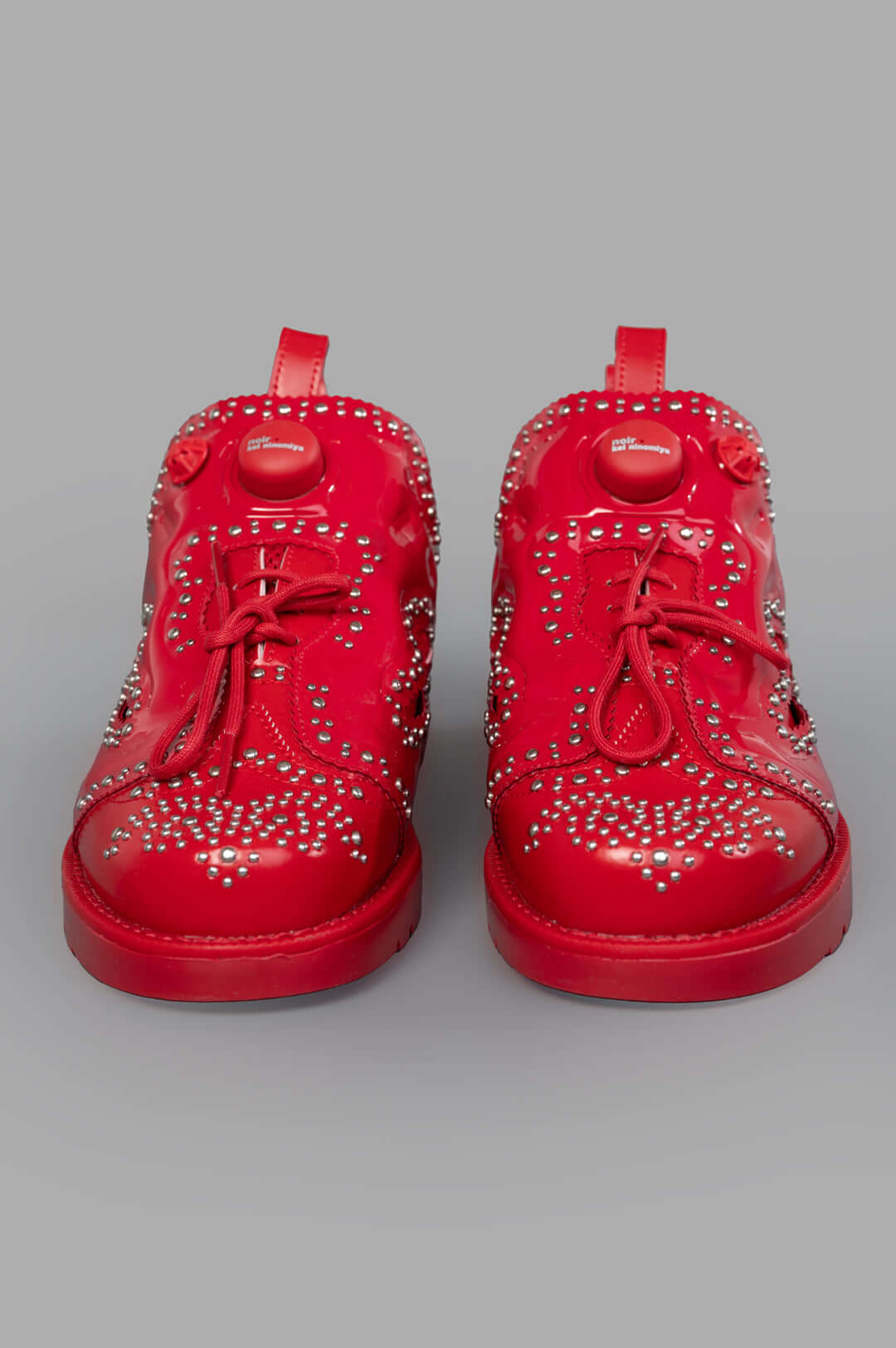 Noir Kei Ninomiya x Reebok Instapump Fury Sneakers in Red, featuring stud embellishments and lace-up detailing, front view.