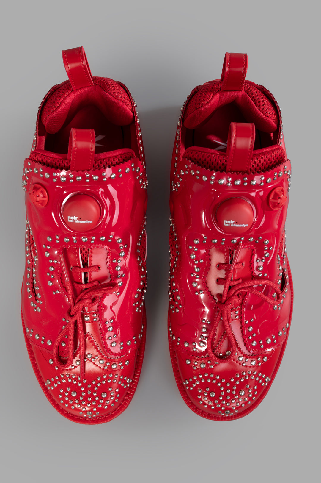 Noir Kei Ninomiya x Reebok Instapump Fury Sneakers in Red, showcasing unique stud accents and innovative pump mechanism, top.
