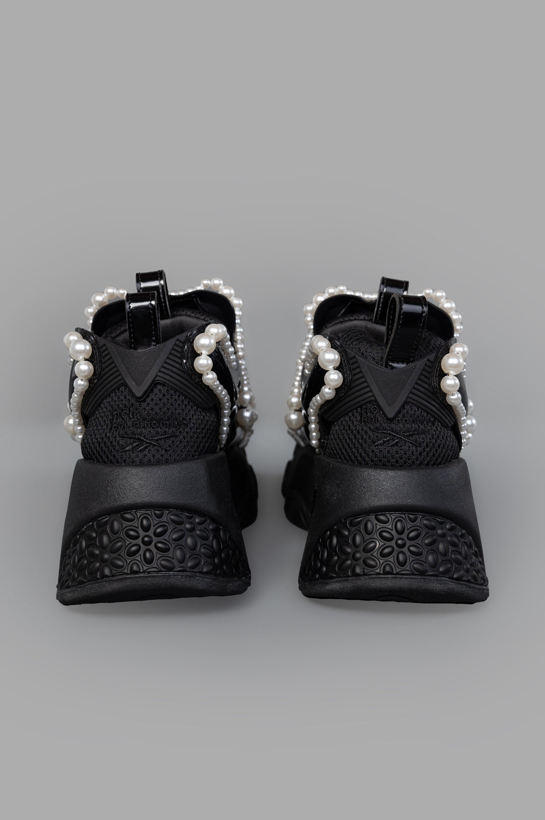 Noir Kei Ninomiya x Reebok Pearl-embellished Sneakers, angled view highlighting unique pearl accents and textured rubber.