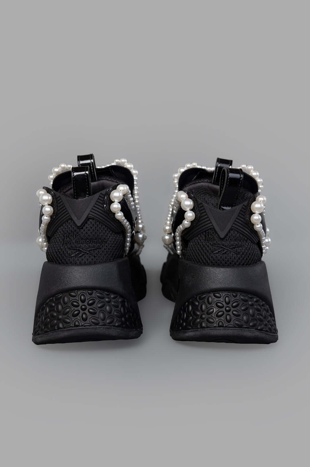 Noir Kei Ninomiya x Reebok Pearl-embellished Sneakers, angled view highlighting unique pearl accents and textured rubber.