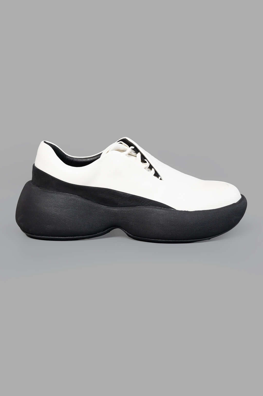 Vein Leather Platform Sneakers, side view showcasing black and white design with elevated rubber platform and rounded.