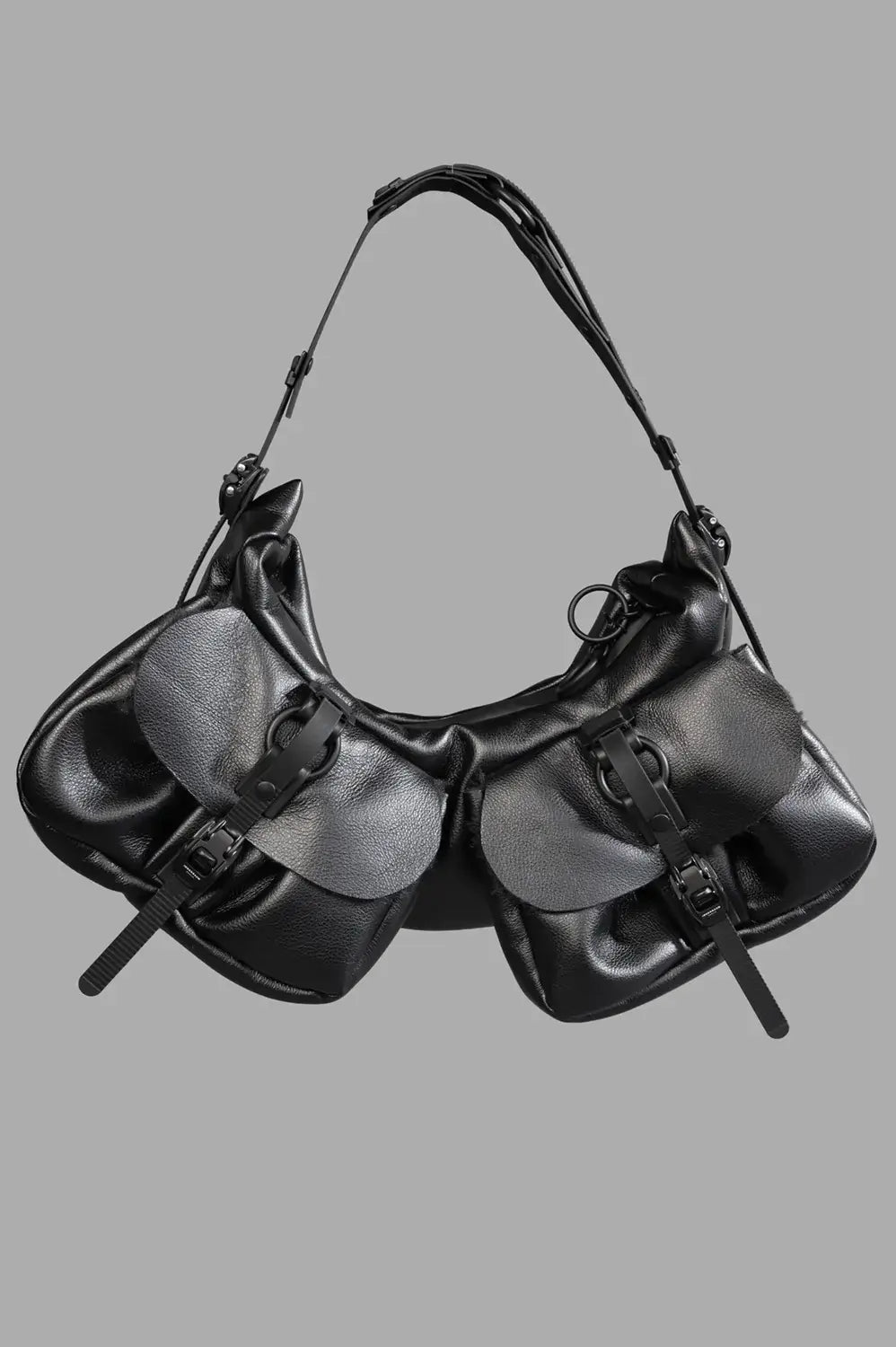 Full-length product view of small half-moon bag in black matt with two front flap pockets and adjustable strap.