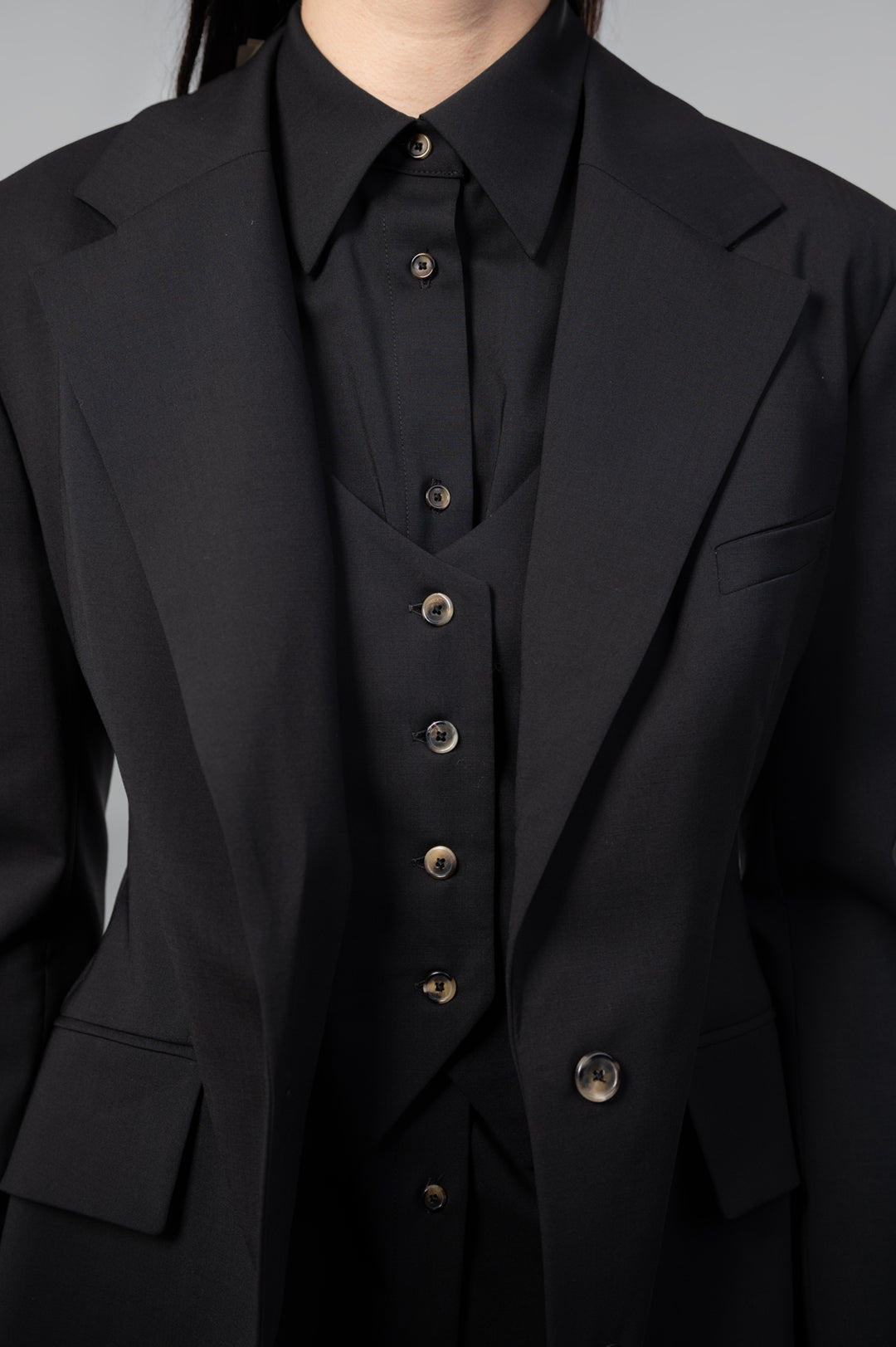 A.W.A.K.E. MODE Open-Back Blazer displayed on a model, featuring a structured front and sleek black fabric details.
