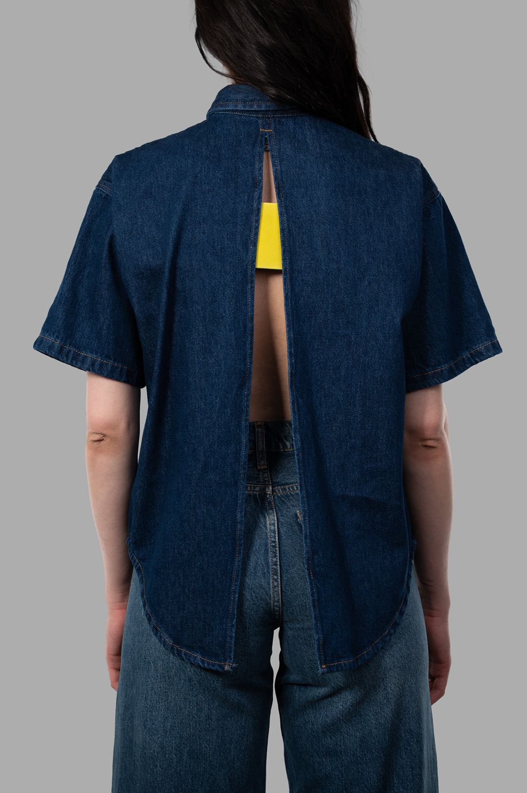MSGM Open-Back Denim Shirt featuring a stylish back cutout; shown in blue denim, highlighting contemporary design elements.