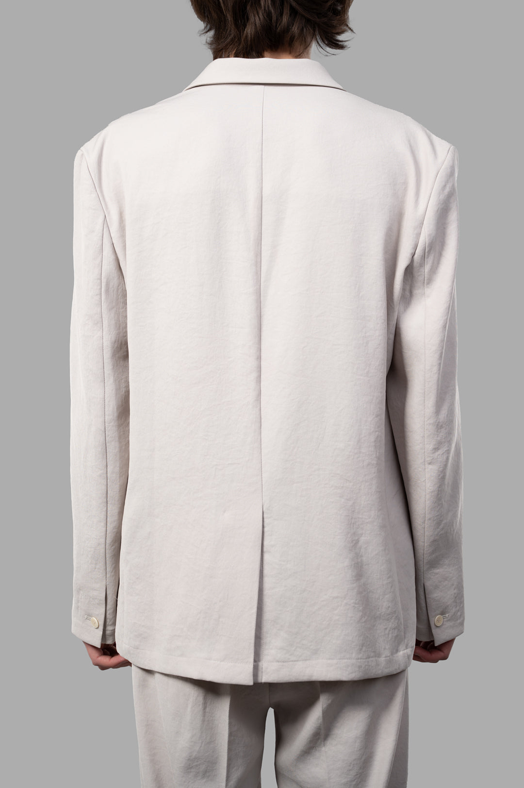 Vein Single-breasted Jacket displayed from the back, featuring a sleek beige design with a central vent for added style.