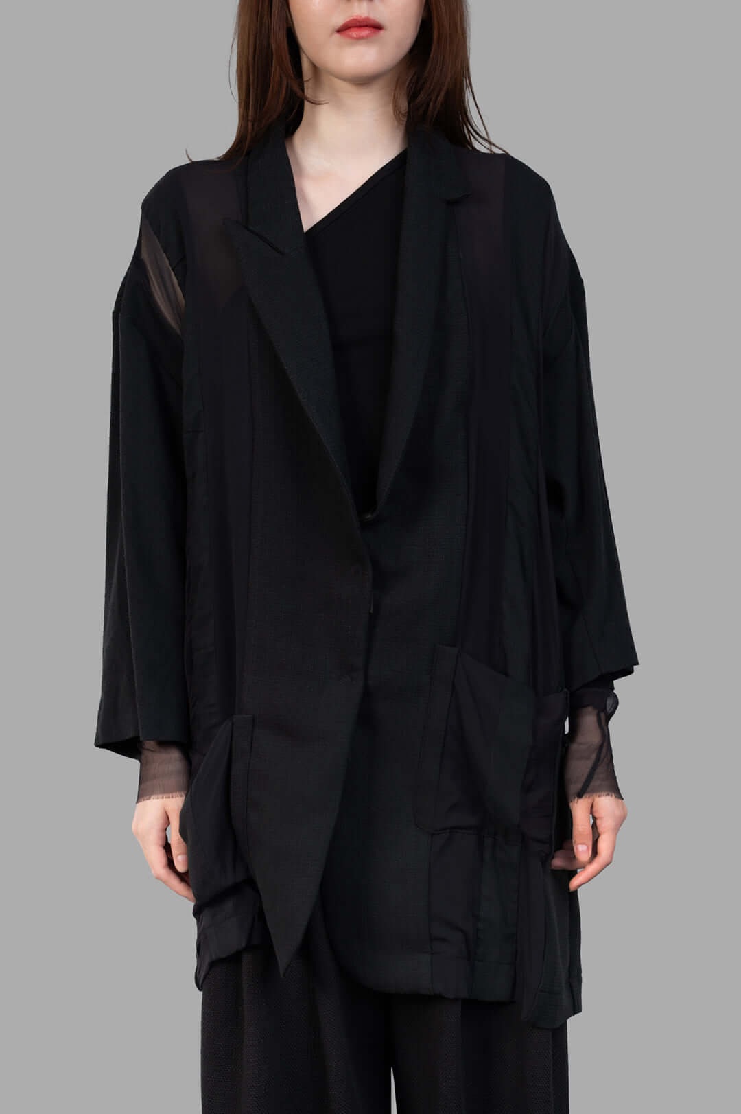 Giovanni Cavagna Paneled Blazer in black, showcasing a relaxed fit, unique textures, and layered detailing on model.