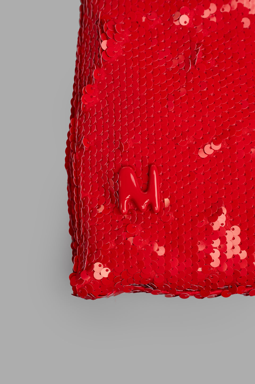 MSGM Red Paillettes Bag close-up showcasing shiny sequins and branded detail, ideal for adding a vibrant touch to any outfit.