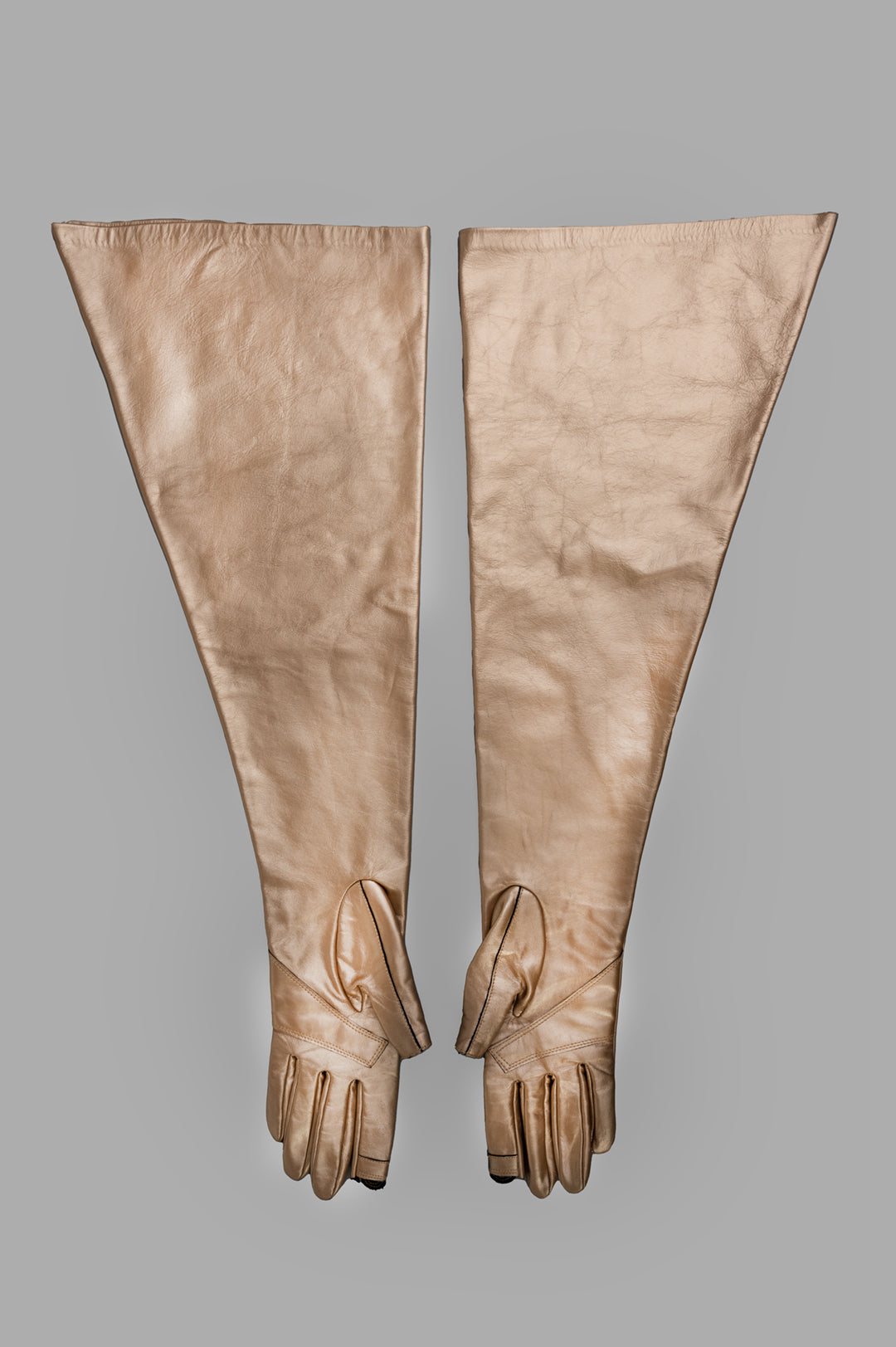 Rick Owens Hollywood Runway Gauntlets in gold calf leather, above-elbow length with cut-out thumb and index fingers.