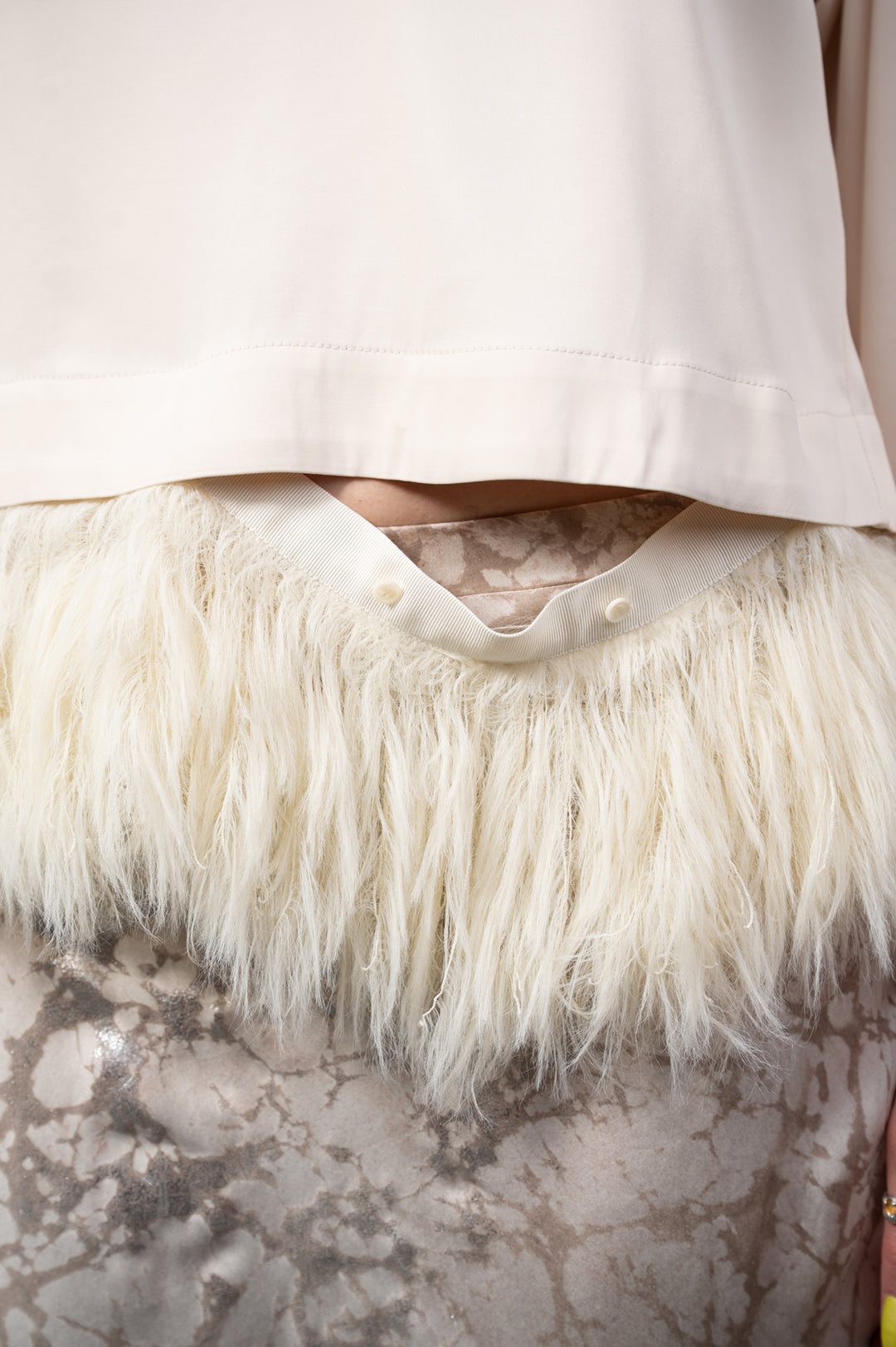 By Malene Birger Scarletts Blouse detail shot showcasing detachable feather trim and minimalist beige fabric design.