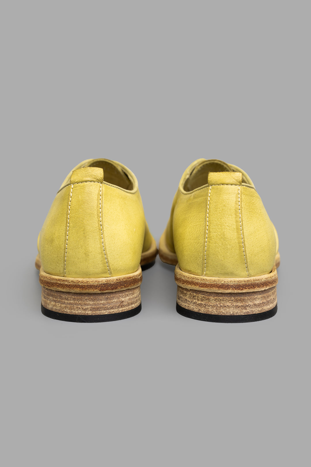 Shoto. Lime Leather Shoes detailed view of the back with unique yellow leather and artisanal finish, showcasing.