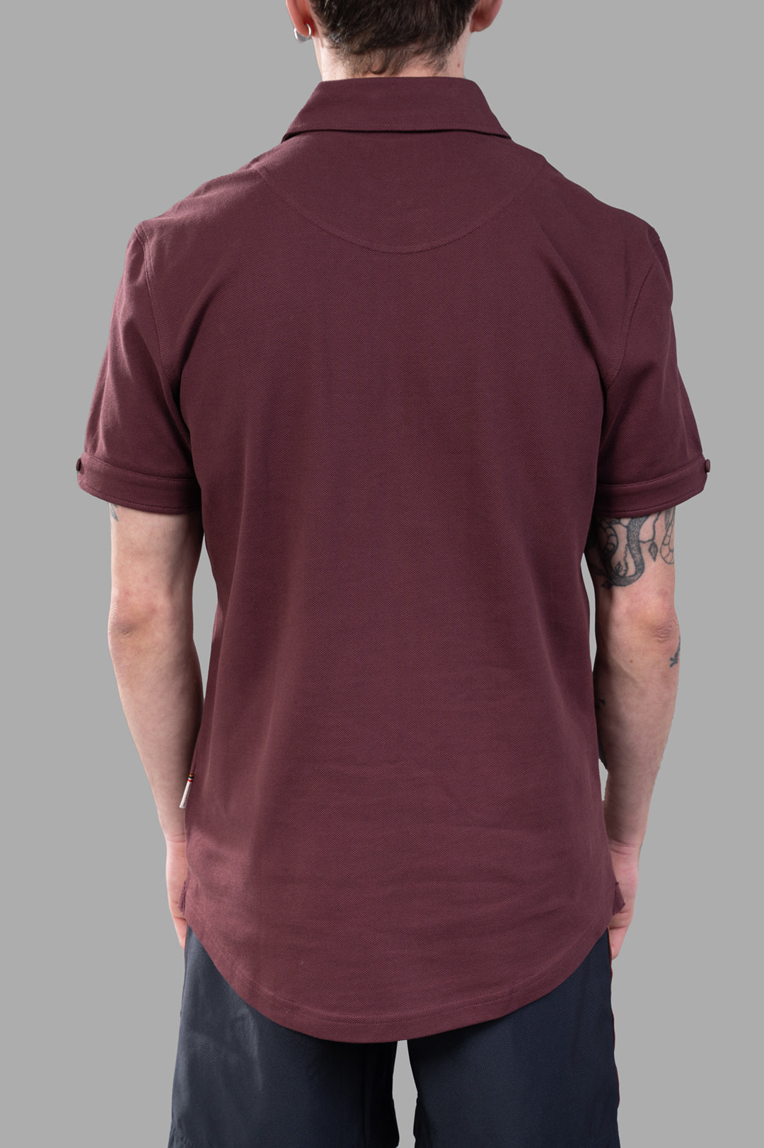 Orlebar Brown Sebastian Polo Shirt in burgundy red, showcasing the back view and soft, lightweight cotton fabric.
