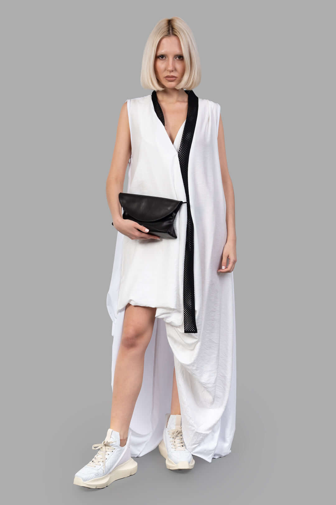 Giovanni Cavagna Asymmetric Dress, front view on model, features a black accent and is paired with white sneakers.